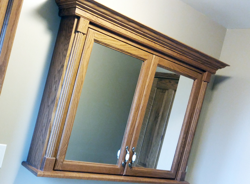 Traditional solid oak mirror cabinet.