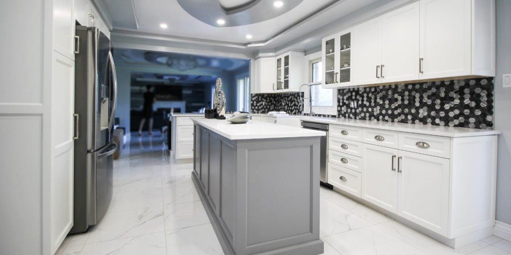 White neo-traditional kitchen with grey island and accents