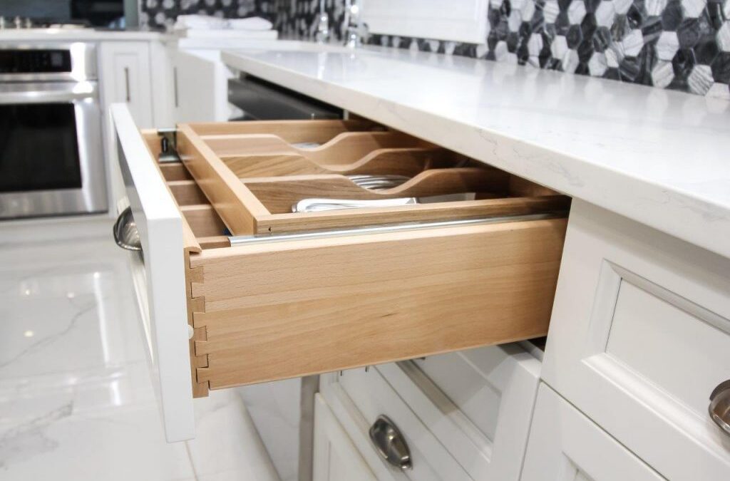 Solid wood drawers constructed with dovetail joint detail and sliding cutlery organizer