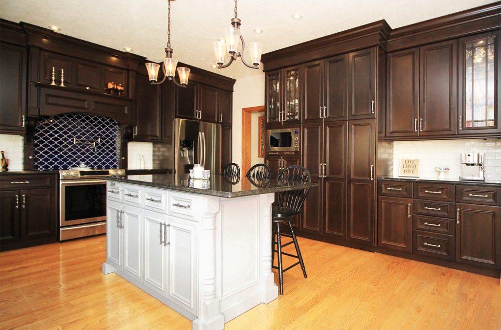 White island provides elegant contrast to dark walnut cabinets