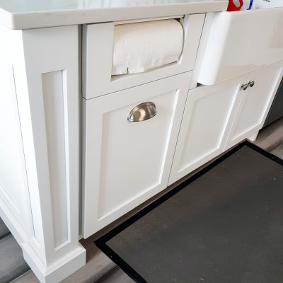 Picture of paper towel dispenser and open storage drawer for additional rolls